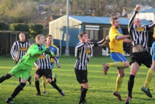 Action as Alnwick Town (stripes) take on Stockton Town in Northern League Division 2.
