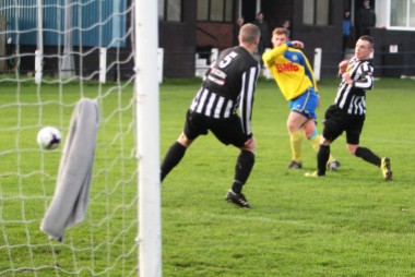 Kallum Hannah (yellow) fires in the opening goal for Stockton at Alnwick Town.
