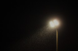Heavy rain falls in front of the floodlight at Willington's Hall Lane ground.